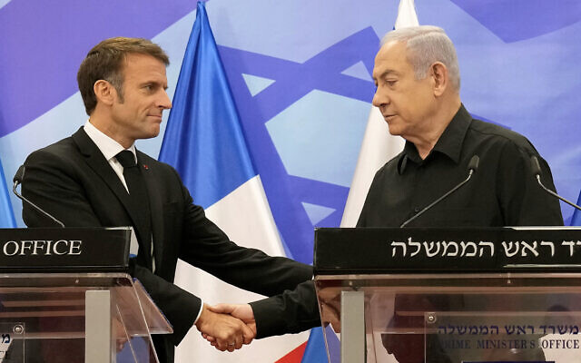 Prime Minister Benjamin Netanyahu (R) shakes hands with French President Emmanuel Macron (L) as they hold a joint press conference in Jerusalem on October 24, 2023.